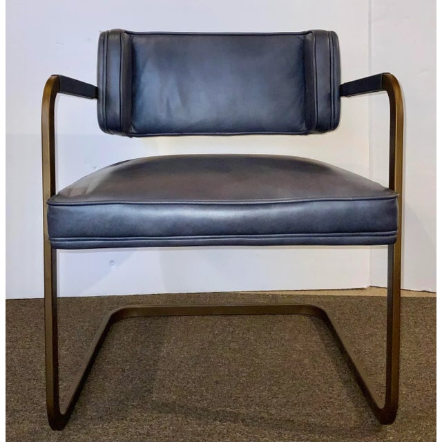 Stylish and timeless Mid-Century Modern Inspired Blue Leather Accent Chair, antique brass finished metal frame, showroom...