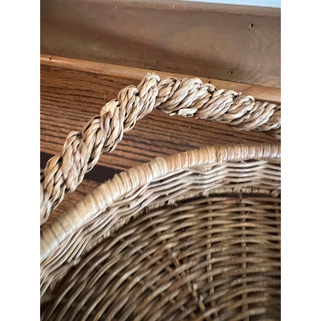 Charming vintage woven wicker and rattan basket crafted in a whimsical fish shape, with a beautifully woven circular body...