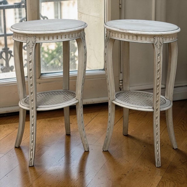 Pair Louis XVI Painted Oval End Tables is a charming duo featuring original painted finish with a soft, timeworn patina....