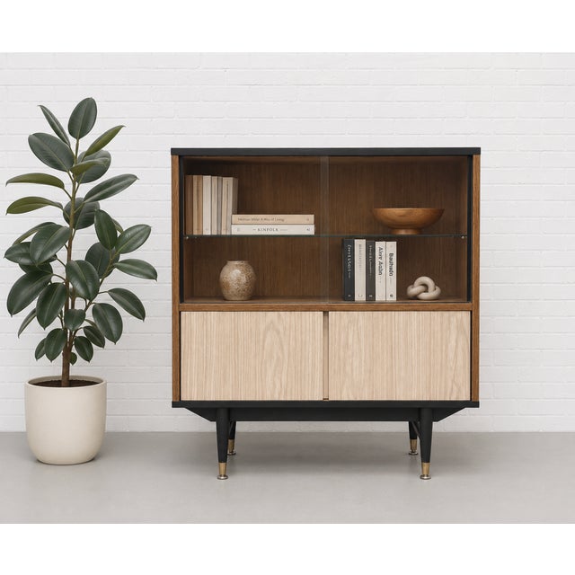 Mid Century modern display cabinet by Berry Furniture, Made in England, c. 1960’s, featuring a warm walnut cabinet paired...