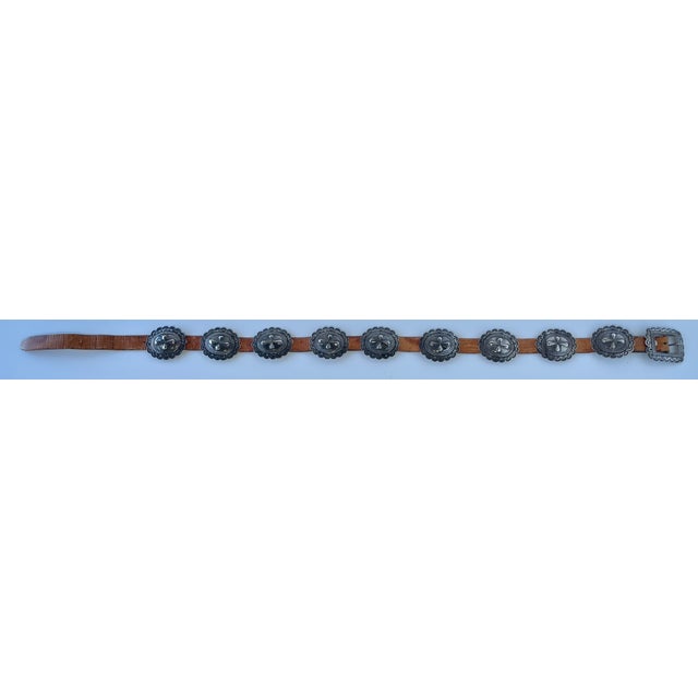 This fantastic belt has 9 heavy hand-stamped silver conchos with scalloped edges; each has a copper loop that attaches it...