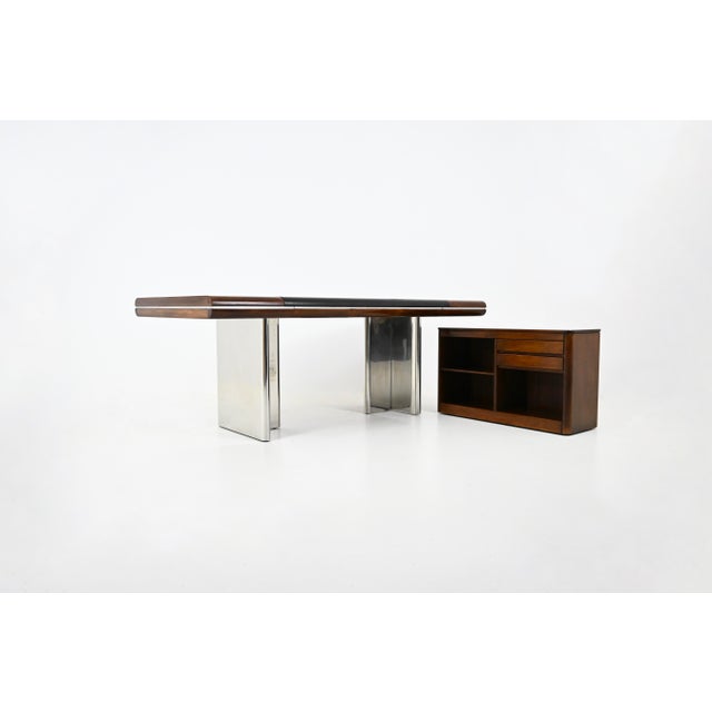 Leather, metal, and wood desk with three drawers and a sideboard on casters that can be moved wherever needed. Designed by...