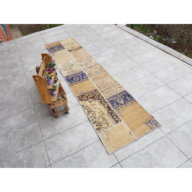 This is a vintage Turkish Oushak rug from the Mid 20th Century. The piece was hand-knotted.