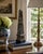 A beautifully proportioned marble obelisk in richly veined shades of black, brown, and gray. The sculptural silhouette and...