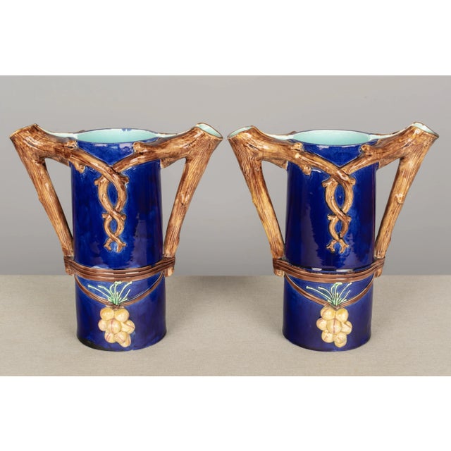 A pair of French Majolica vases or pitchers, each with double tree branch form handles and spouts. Deep, rich cobalt blue...
