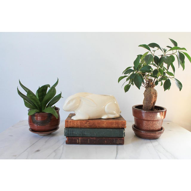 Vintage ceramic white bunny rabbit planter. No makers mark. Crazing and chip on front paws. Pictured.