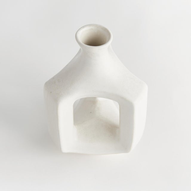 Simple and wide open in form with a matteWhite glaze, this decorative vase is a truly modern accent. Perfect for a single...