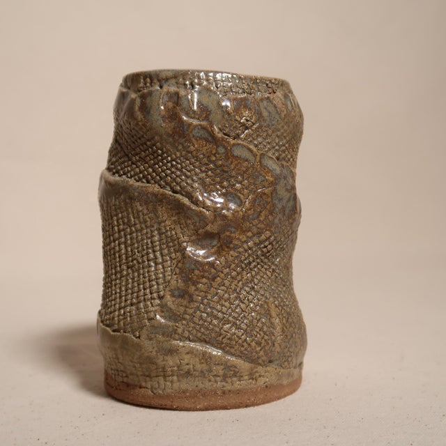 This hand-formed studio pottery vase embodies the artistry of organic modern ceramics. Crafted with intention, the vessel...