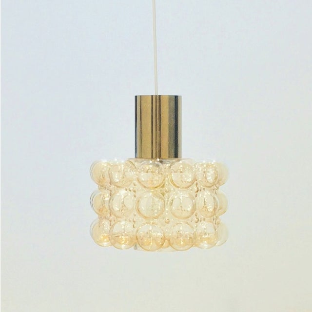 Large mid-century modern pendant/ceiling light by Helena Tynell for Limburg (Germany, 1960s). Light amber hand blown...