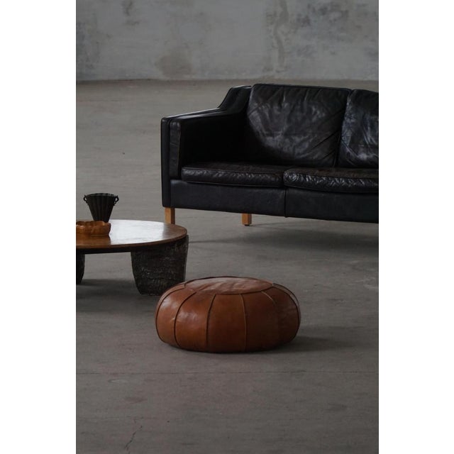 A beautiful handcrafted Moroccan leather pouf, showcasing exquisite craftsmanship with a classic rosette design. Made from...