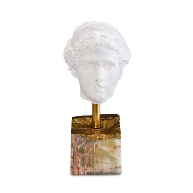 A timeless meditation on beauty and form, the sculpture captures the serene grace of classical antiquity. The finely...