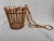Mid Century rattan hanging basket. Great condition. It measures overall 7 1/4" in diameter by 24 1/2" in height. The...