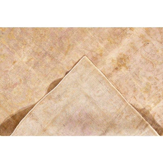 Beautiful Antique Overdyed hand-knotted wool rug with a beige field. This Persian rug has a multi-color accent in a...