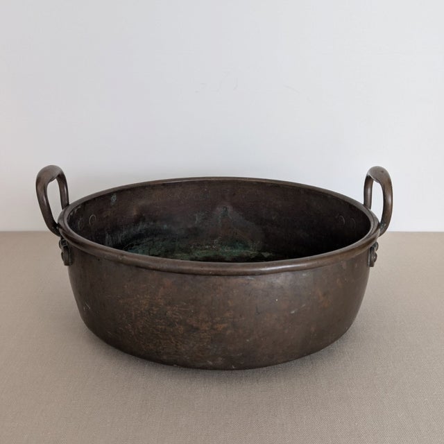 A large 19th-century copper preserve pan, traditionally used for making jams, marmalades, and preserves. The wide circular...