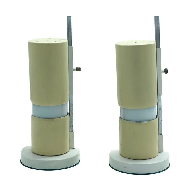 Pair of adjustable table lamps with constructivist form is attributed to Italian designer Angelo Lelli. The cylindrical...