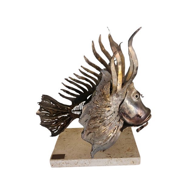 The Lionfish by Puccio Giachetti is a torch cut steel in a brutalist style sculpture, and it is mounted on travertine...