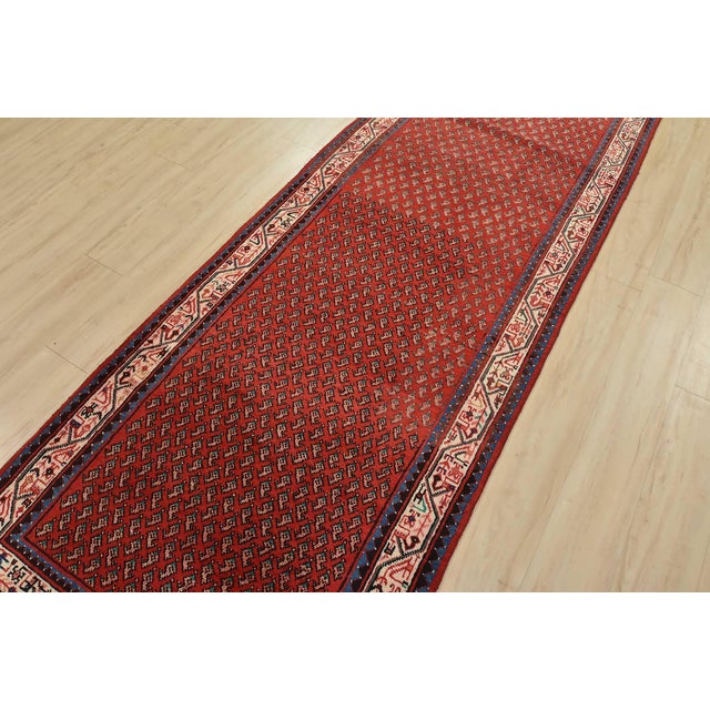 An authentic vintage tribal Mir runner hand-knotted with fine wool and natural dyes. This nomadic oriental rug features an...