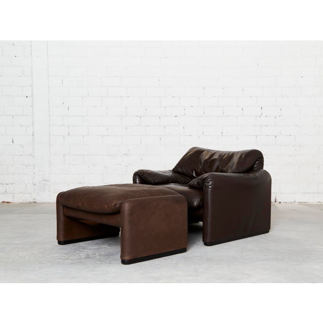 Maralunga armchair by Vico Magistretti. Upholstered in high-quality dark brown leather. The ottoman is slightly lighter. I...