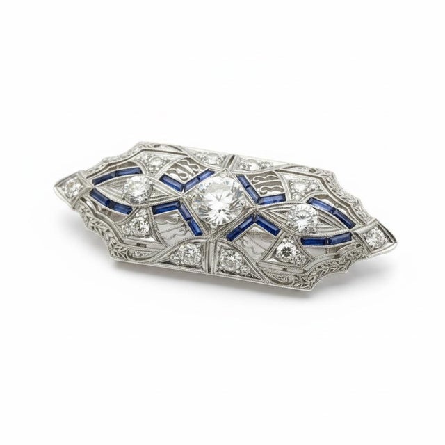 Platinum Art Deco Brooch / Pendant with 1 old european diamond weighing approximately 1.25 carats and 10 smaller old...