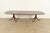 An exceptional Georgian or Regency style double pedestal extension dining table In the manner of Baker Furniture USA,...