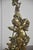 A decorative pair of solid brass door stops cast as winged putti in the Rococo taste. Each cherub is shown in animated...