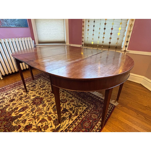 Stunning traditional Queen Anne style mahogany dining table with drop-leaf extension and tapered legs. Likely early to...