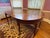 Stunning traditional Queen Anne style mahogany dining table with drop-leaf extension and tapered legs. Likely early to...