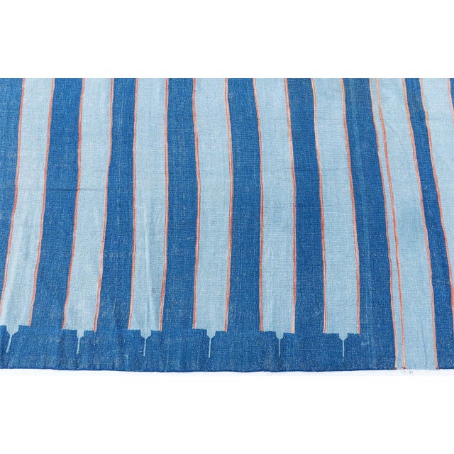 This vintage 1955 Indian Dhurrie rug showcases a beautifully balanced interplay of color, rhythm, and artisanal...
