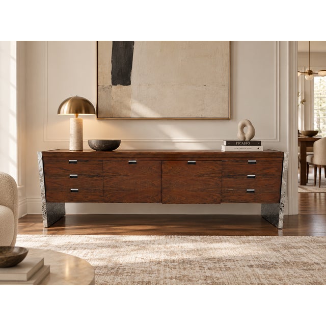 An exceptional 1970s rosewood and chrome credenza attributed to Roger Sprunger for Dunbar Furniture, showcasing the...
