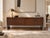 An exceptional 1970s rosewood and chrome credenza attributed to Roger Sprunger for Dunbar Furniture, showcasing the...