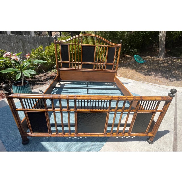 Stunning vintage bed by Baker Furniture! It features a king size rattan bed frame with bamboo accents and black leather...