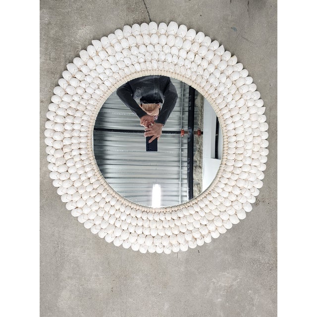 Beautiful coastal style handcrafted round seashell framed mirror with crochet trims. Featuring hand tied white moon snail...