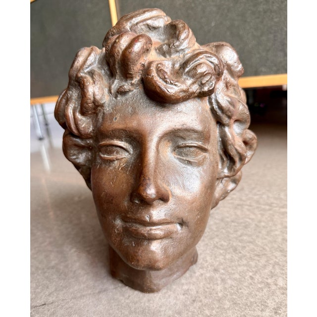 Vintage cast bronze sculptural head fragment, originally part of a life-size figural sculpture, made in Europe circa 1950....