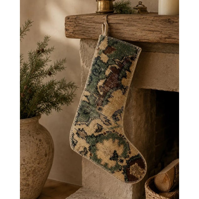 Cut from a genuine vintage Turkish wool kilim, this stocking features an earthy geometric pattern in forest green,...