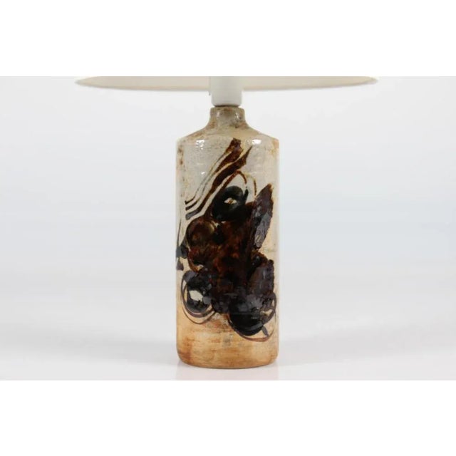 Danish mid-century ceramic artistic stoneware lamp base designed by artist conny walther. the lamp base has an abstract...