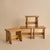 An Italian ash wood stool from the 1960s, defined by a solid square seat with softened edges, set on slab-style legs...