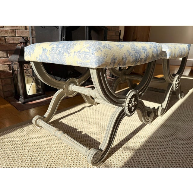 Pair of Neo-Classical Style Painted Benches Upholstered in Heritage Blue and Yellow Toile This pair of X-Benches radiates...