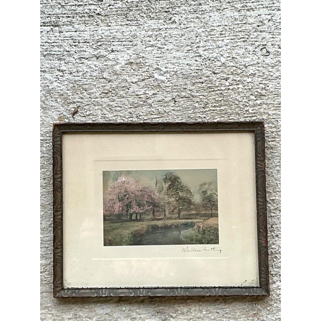 This vintage hand-colored landscape print by renowned American photographer and artist Wallace Nutting captures the...