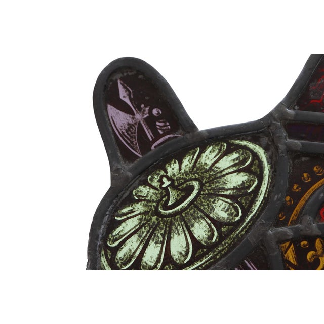 A stained glass suncatcher panel featuring the heraldic shield of William the Conqueror, with two lions, a crown, and...