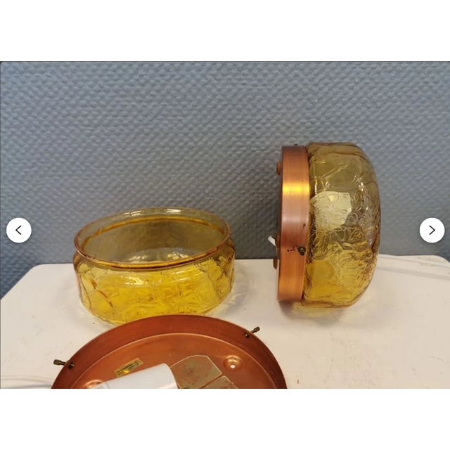 A sensational and unique pair of amber glass wall sconces, model "diskus", created by legendary swedish designer holger...