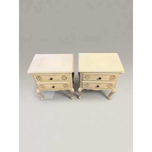 A seriously stylish pair of vintage French nightstands, finished in a gorgeous off-white crackle glaze that brings heaps...