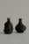 A pair of small, hand-formed brutalist vessels defined by their irregular, raw and elemental surface and sculptural...