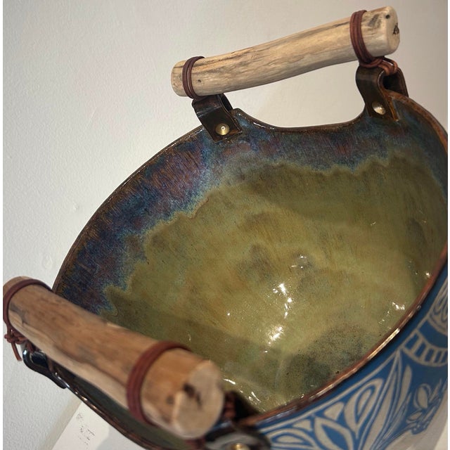 Contemporary, made to order, food-safe oval bowl with wooden handles that are attached by leather and ceramic strips. “The...