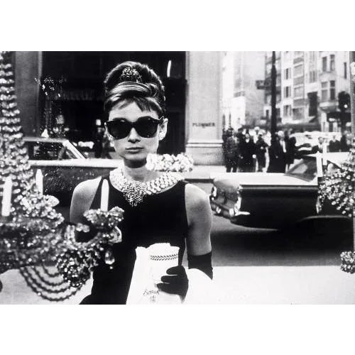 Audrey Hepburn in "Breakfast at Tiffany's" Aubrey Hepburn starring in "Breakfast at Tiffany's", posed looking through a...