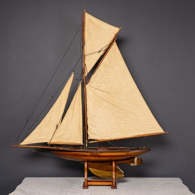 A 20th Century English gaff rigged pond yacht, complete with calico sails, brass fittings, and a brass rudder and keel,...