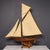 A 20th Century English gaff rigged pond yacht, complete with calico sails, brass fittings, and a brass rudder and keel,...