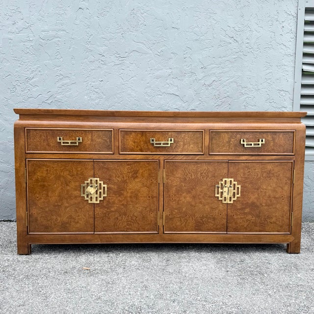 This vintage chinoiserie credenza by Century Furniture showcases richly figured burlwood within a warm honey brown frame....
