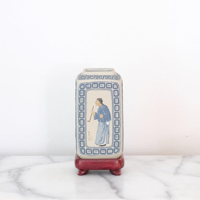 Chinese Yixing ceramic vase from the early 20th century. The glaze is matte. The wooden base comes with the vase.