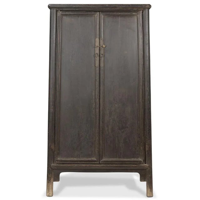 This antique elm cabinet from Shanxi, circa 1870, features a black lacquer finish, iron hardware, and a unique 'round...