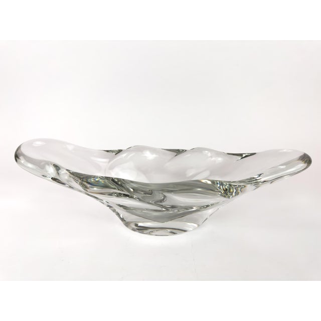 Freeform clear crystal centerpiece bowl by Daum France, produced circa 1965–1985. This sculptural bowl features an...